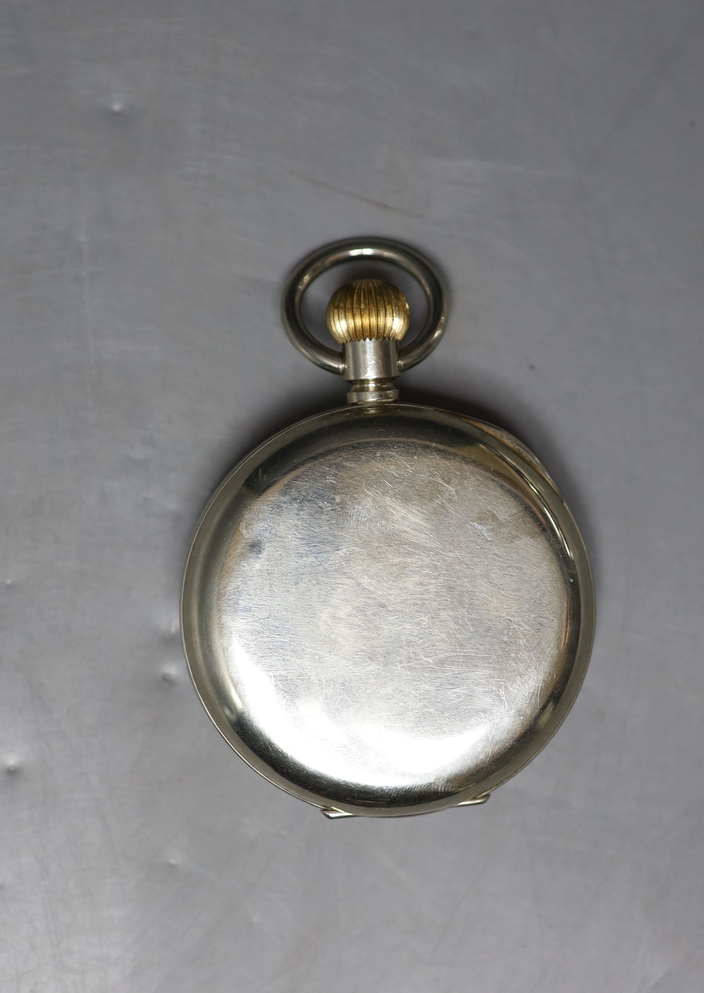 A George V engine turned silver mounted travelling watch case, with nickel cased 8 day pocket watch, 11.6cm, lacks easel.